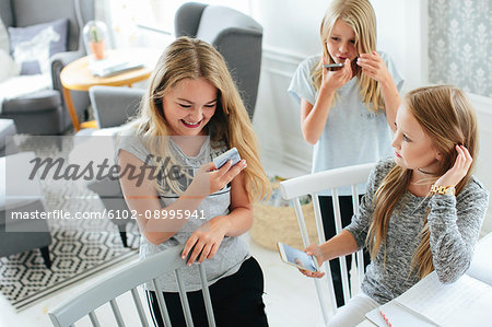 Happy girls using cell phones