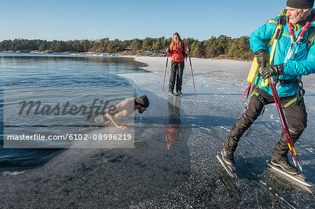 Man getting out of freezing water
