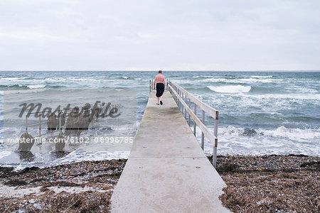 Man walking on pier