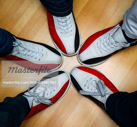 children's feet in shoes and a bowling ball for the game