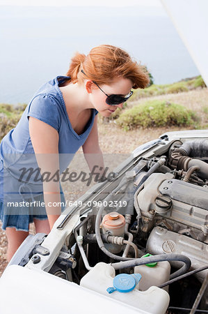 Woman looking at broken engine