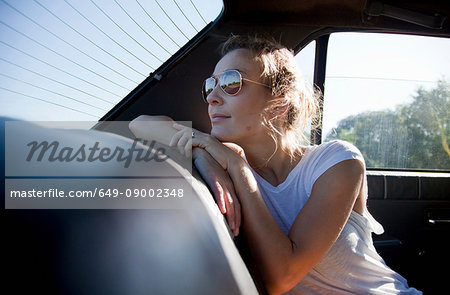 Woman in the back of a car, looking out