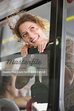 Woman looking out of a bus window