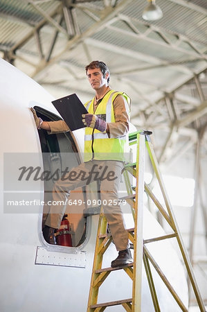 Aircraft worker checking airplane