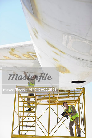 Aircraft workers repairing airplane