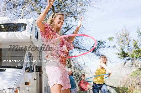 Family using hula hoops with RV