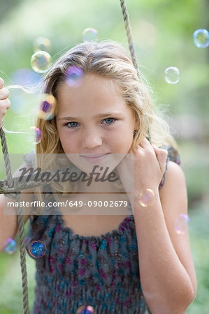 Girl climbing rope ladder with bubbles