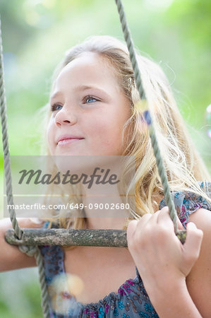 Girl climbing rope ladder