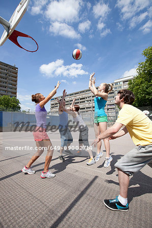 Friends playing basketball together