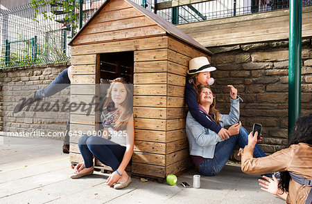 Teenagers playing in playhouse