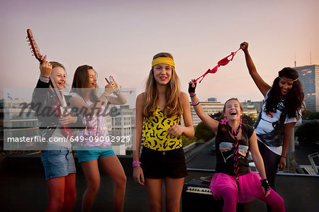 Teenage girls playing music on roof