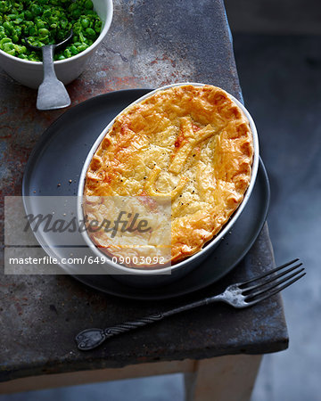 Dish of baked pie and peas