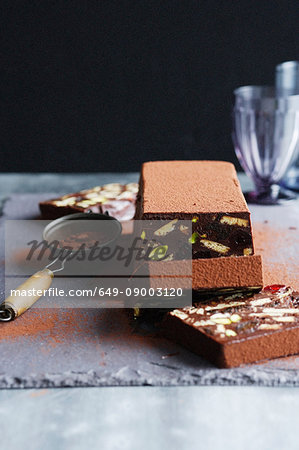 Sliced chocolate cake on board