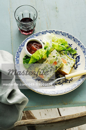 Plate of quiche with jam and lettuce