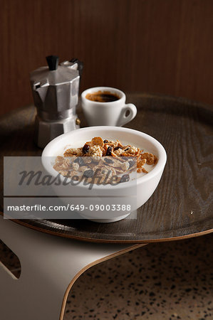 Bowl of granola with cup of coffee