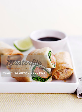 Dish of egg rolls with dip