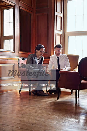 Businessmen talking in ornate room