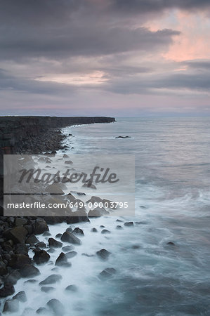 Waves washing up on rocky coastline