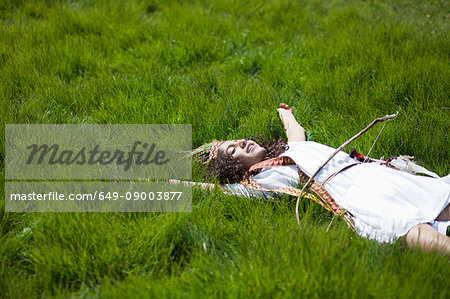 Girl in Native American costume in grass