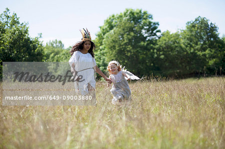 Girls in costumes walking in field