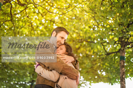 Couple hugging in park