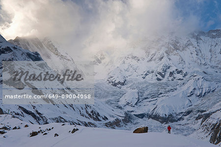 Hiker in snowy mountain landscape