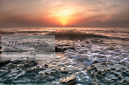 Water washing over rocks on beach