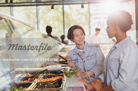 Young lesbian couple at salad bar in market