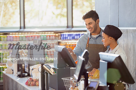 Cashiers working at grocery store checkout