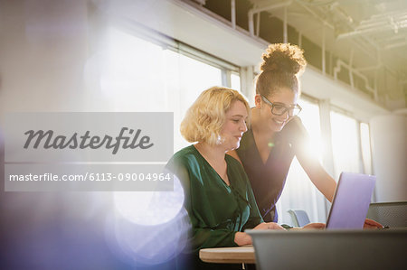 Businesswomen using laptop in office