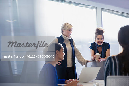 Businesswomen talking, working in conference room meeting