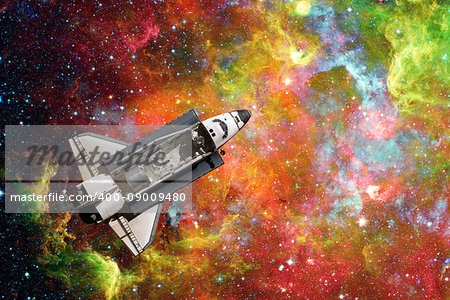 Space Shuttle flight over space nebula. Elements of this image furnished by NASA.