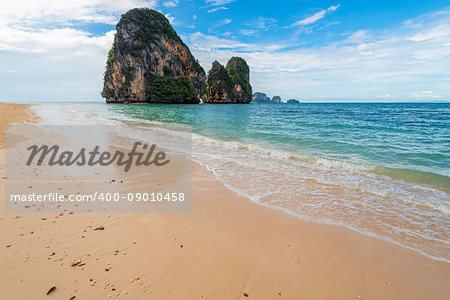 Waves on the shores of the Andaman Sea and a view of the rock