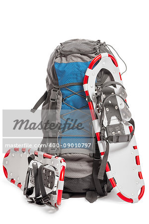 a pair of snowshoes and backpack traveler in the winter