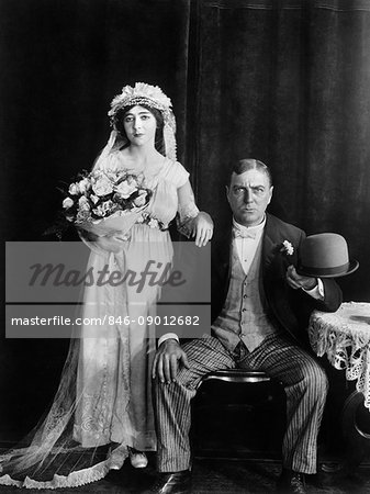 1890s 1910s WEDDING PORTRAIT SERIOUS BRIDE AND GROOM LOOKING AT CAMERA SILENT MOVIE STILL