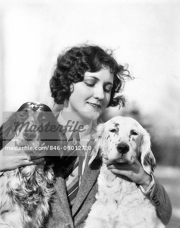 1920s WOMAN HOLDING PETTING TWO ENGLISH SETTER DOGS OUTDOORS