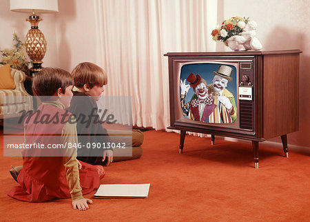 1960s TWO CHILDREN BOY GIRL SITTING RED CARPET LIVING ROOM WATCHING TV TELEVISION ENTERTAINMENT MEDIA