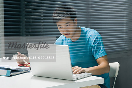 Man on laptop with takeaway