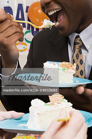 Office workers eating party cake
