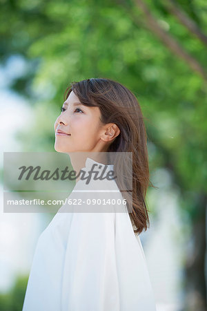 Portrait of young Japanese woman and fresh green, Tokyo, Japan
