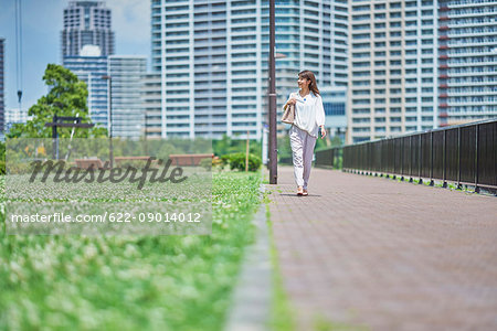 Portrait of young Japanese woman in a city park, Tokyo, Japan