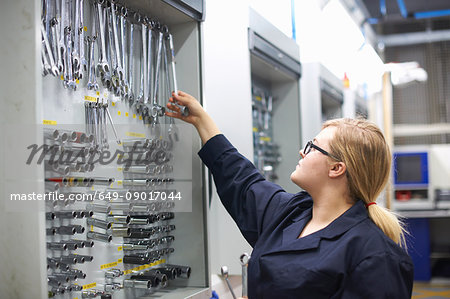 Student at car maintenance class choosing tools