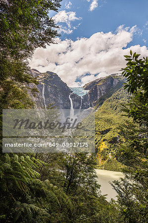 View of waterfall flowing from glazier at edge of mountain rock face, Queulat National Park, Chile View of waterfall flowing from glazier at edge of mountain rock face, Queulat National Park, Chile