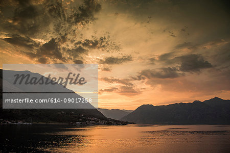 Silhouette of mountains by water at sunset, Kotor, Montenegro, Europe