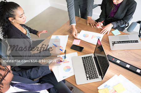 Businessman and businesswomen, in office, using laptops