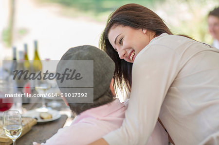 Daughter hugging father at family lunch