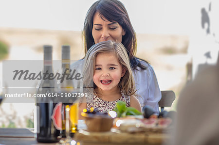 Mother and daughter having lunch outdoors