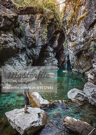 Mid adult tourist looking at river Azul gorge, Cajon del Azul near El Bolson, Patagonia, Argentina