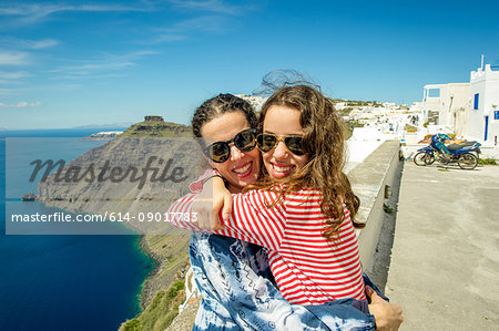 Mother and daughter hugging, sea in background, O'a, Santorini, Kikladhes, Greece
