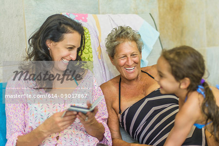 Girl with mother and grandmother on deckchair